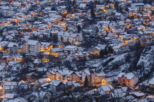 Aerial view of a residential district of Brasov city at dusk, during winter, Romania.