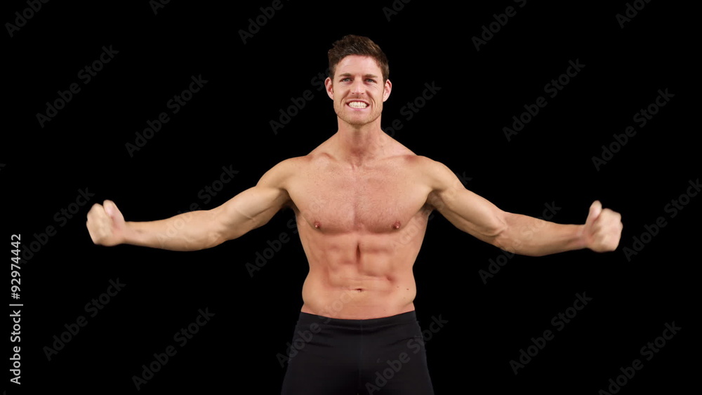 Muscular man flexing muscles in front of camera Muscular man flexing muscles in front of camera
