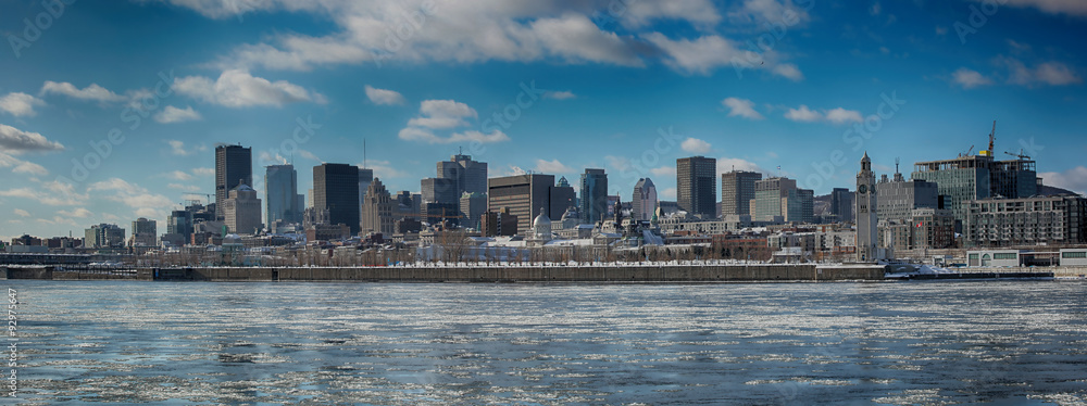 Montreal by a very cold day.  St-Lawrence river with ice with downtown Montreal in background
