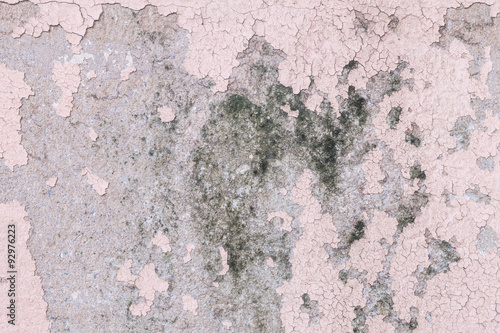 Closeup pale color and peeling of painted pink cement wall texture background