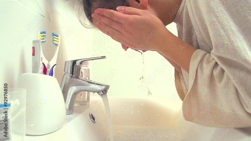 Beautiful teenage girl washing her face Beautiful teenage girl washing her face