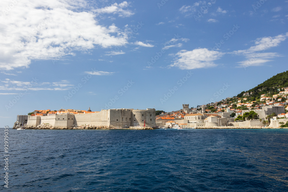 City Walls and buildings on the hillside in Dubrovnik, Croatia, viewed from the sea. Copy space.