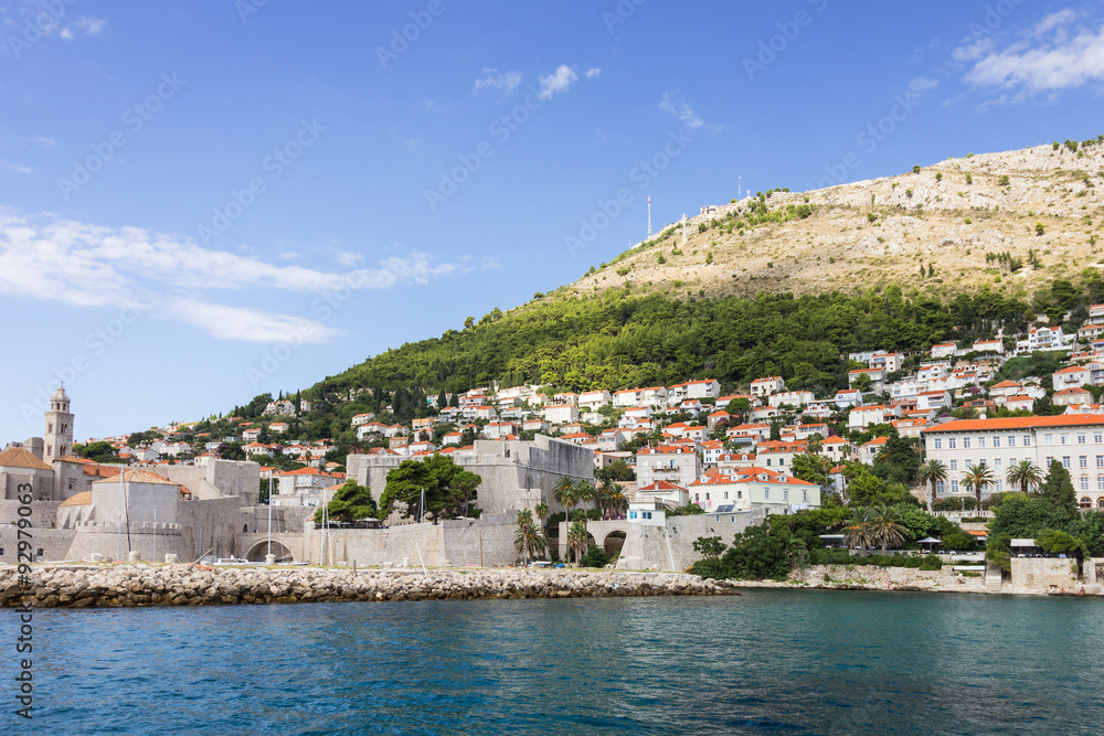 View of the walled Old Town, buildings on the hillside and Mount Srd from the sea in Croatia.