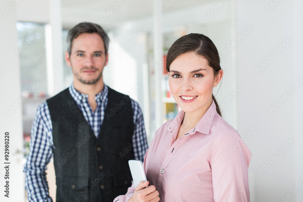 Two coworkers are standing in the hallway of a luminous open spa Two coworkers are standing in the hallway of a luminous open spa