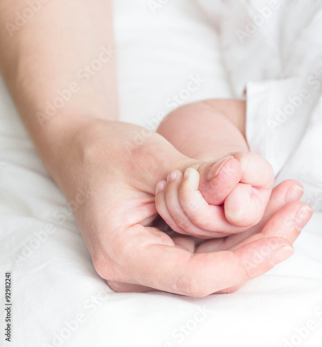 Mother's finger and baby hand