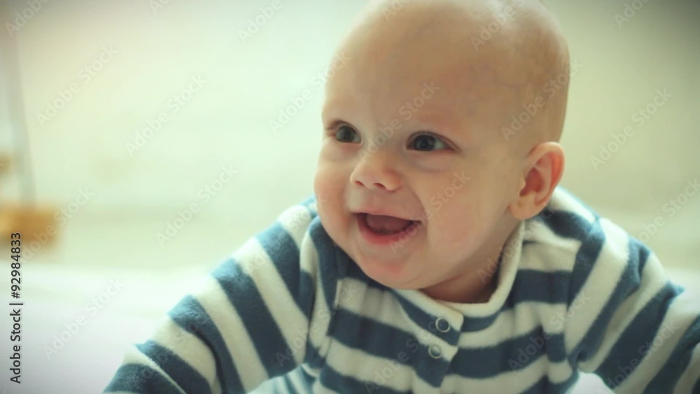 Joyful kid smiling on floor Joyful kid smiling on floor