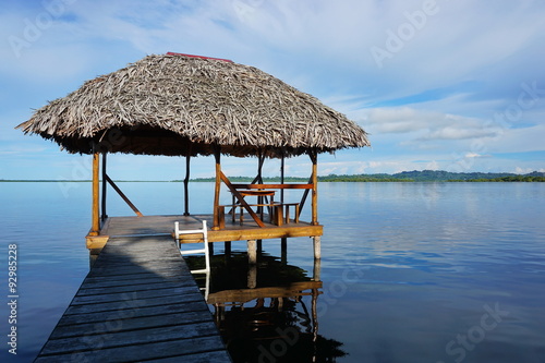 Tropical hut palapa over the water