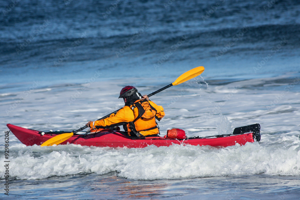 Man fighting the wave on kayak  on rough sea