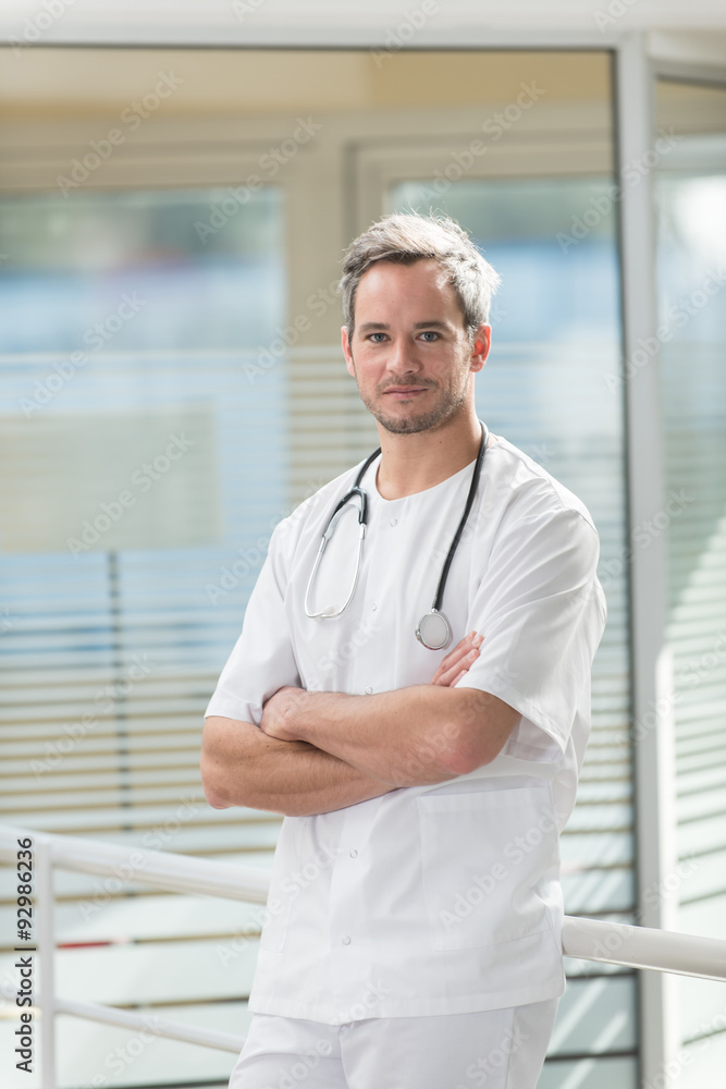 A nice grey hair doctor with beard is standing in his white coat A nice grey hair doctor with beard is standing in his white coat