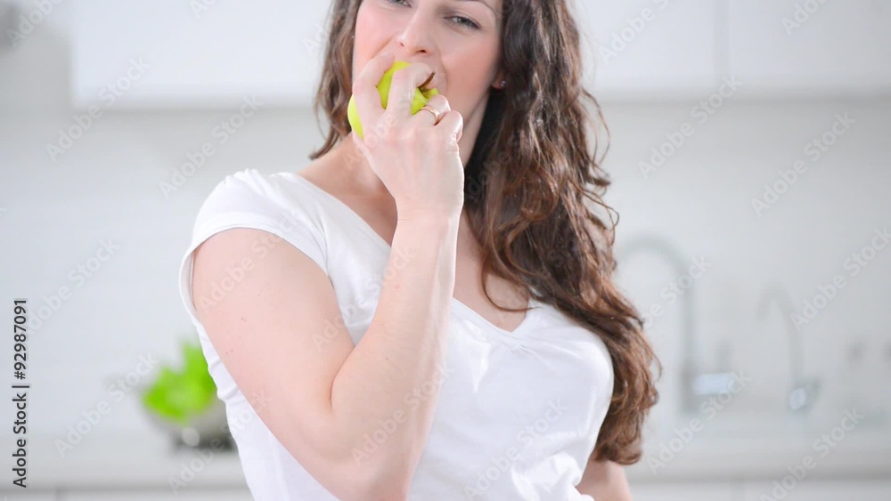 Young smiling pregnant woman eating an apple Young smiling pregnant woman eating an apple