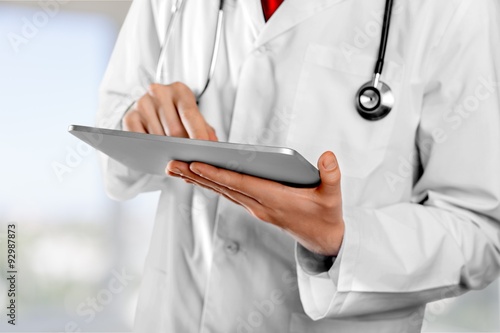 Doctor using tablet.