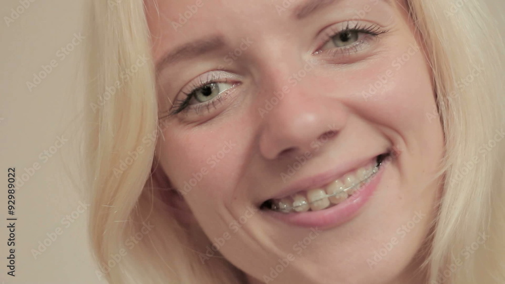 Smiling young girl with braces on teeth looking at camera Smiling young girl with braces on teeth looking at camera
