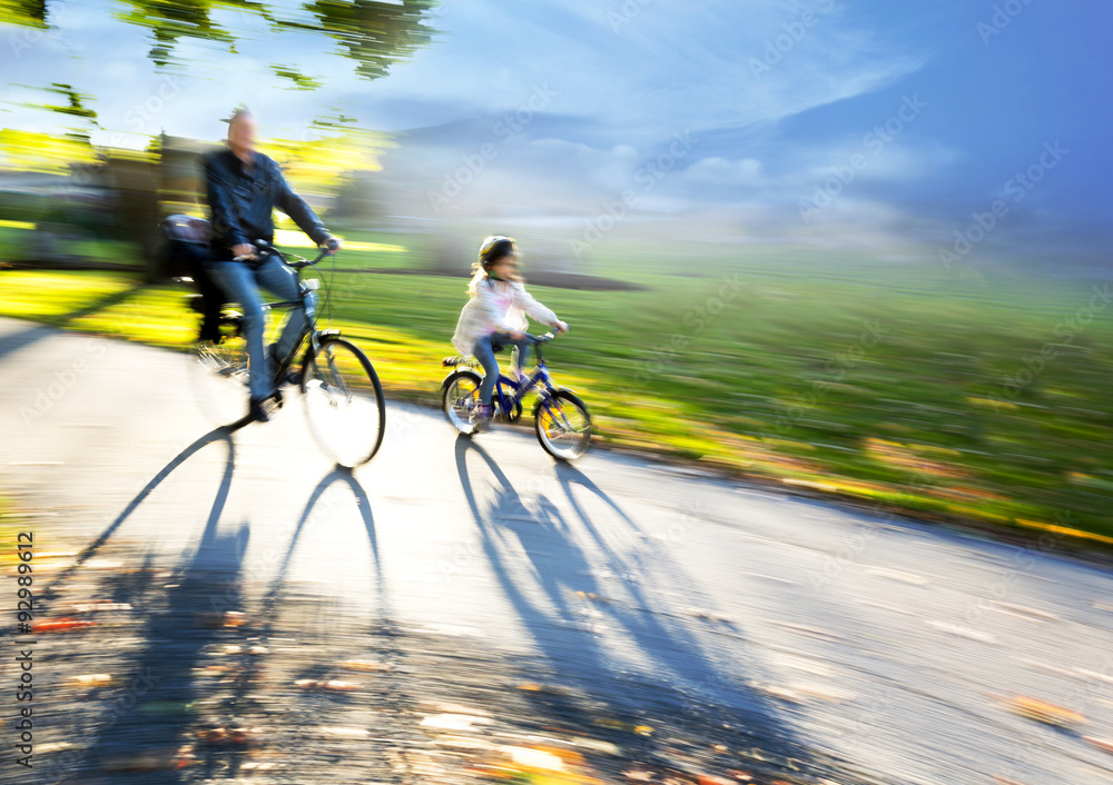 Naklejka premium Man and young girl cycling