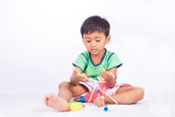 little asian boy play toy tool plastic and count finger on white