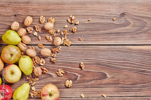 Apples and nuts on a wooden table