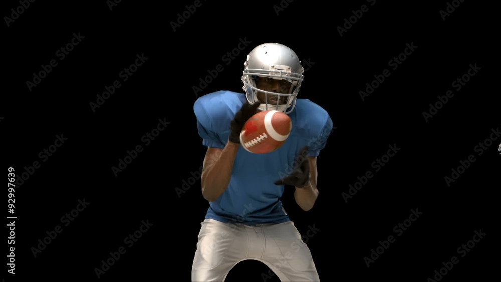 Serious american football player tackling for ball Serious american football player tackling for ball