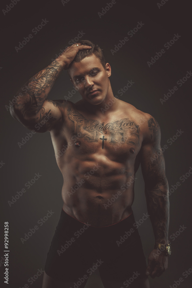 Strong shirtless tattooed man.