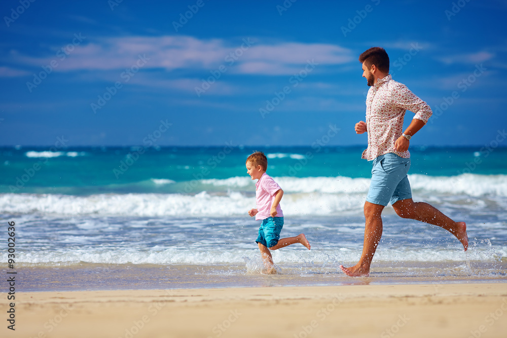 happy excited father and son running on summer beach, enjoy life happy excited father and son running on summer beach, enjoy life