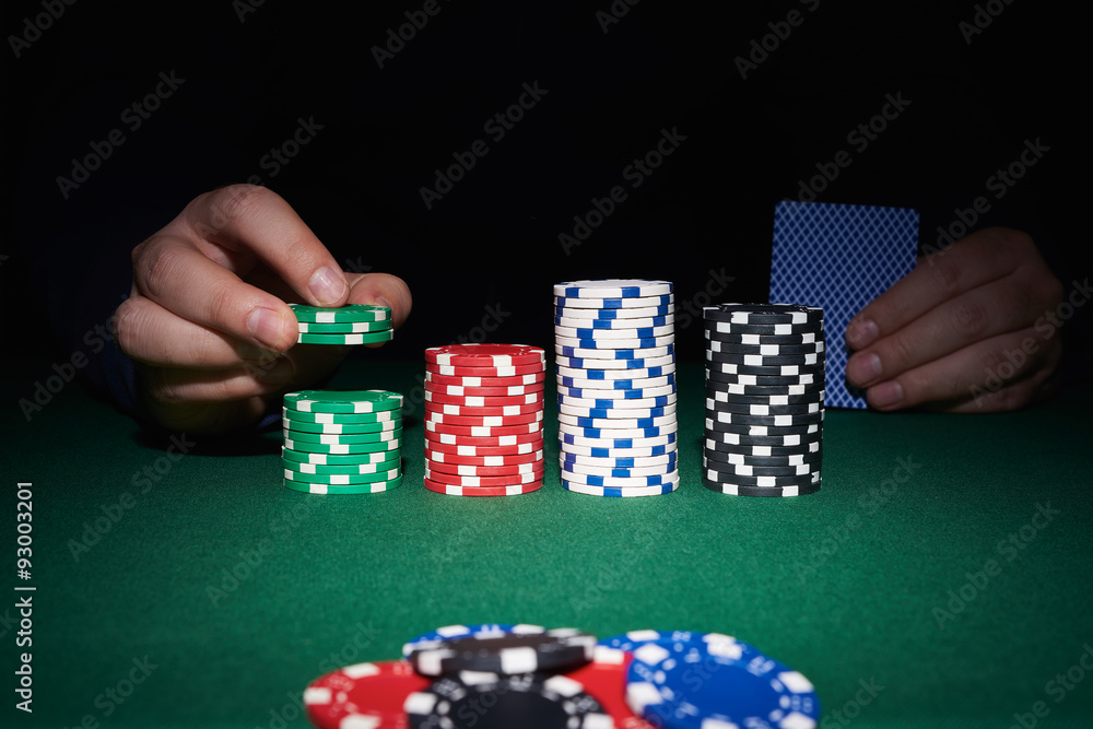 Poker chips on table with hands and cards Poker chips on table with hands and cards
