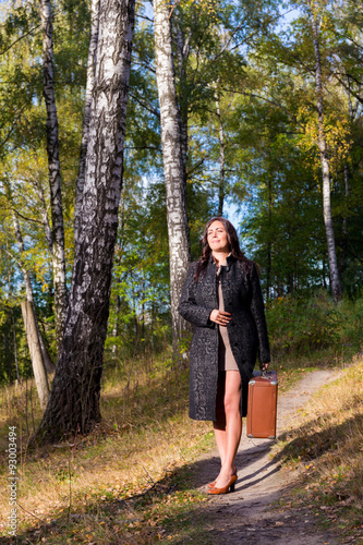 Woman in the park with old fashion trunk