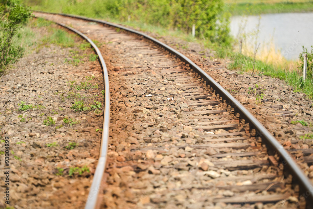 detail of an old railway that runs along a lake in the country detail of an old railway that runs along a lake in the country