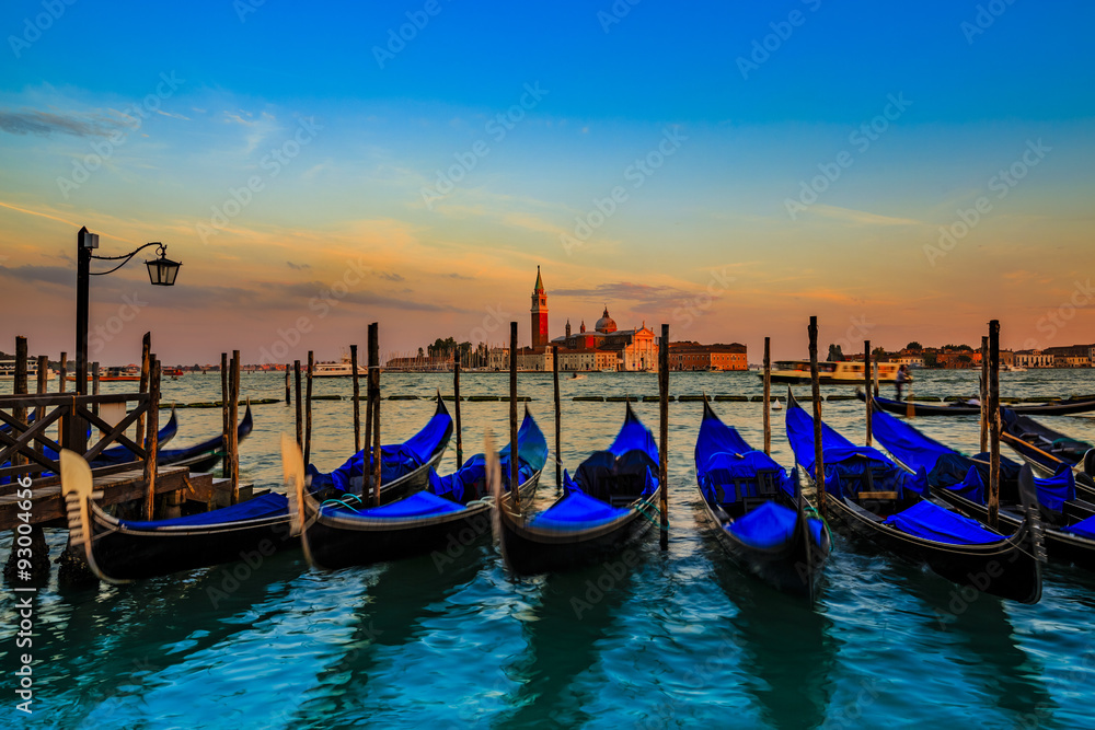 Gondolas in Venice - sunset with San Giorgio Maggiore church. San Marco, Venice, Italy. (filtered)
