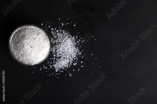sea salt on a plate isolated on black background