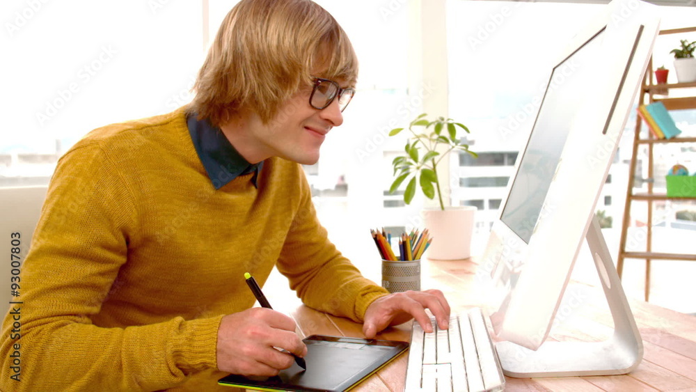 Young creative businessman drawing on graphic tablet Young creative businessman drawing on graphic tablet