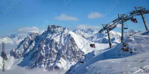 Ski lift and snowy peaks in the Alps, France © Delphotostock