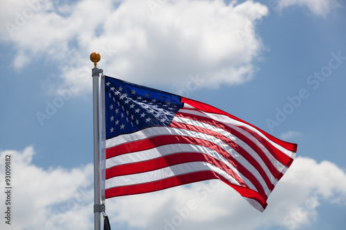 American flag against blue cloudy sky