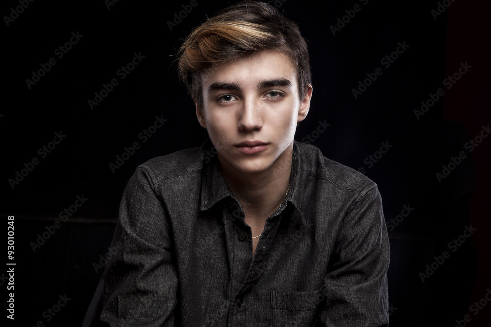 portrait of a young handsome man on black background portrait of a young handsome man on black background