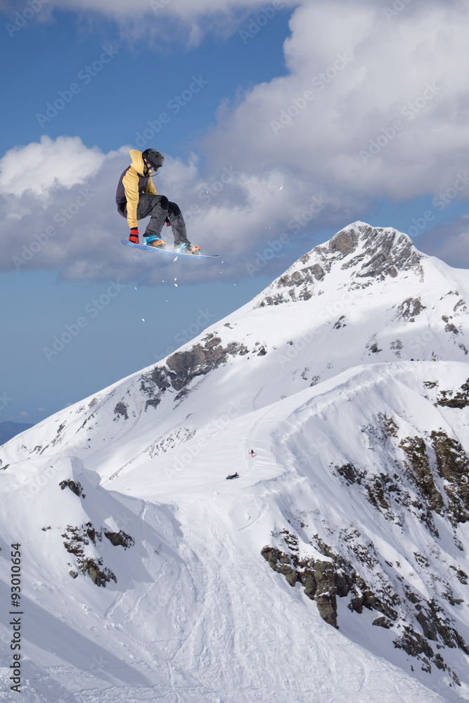 Flying snowboarder on mountains Flying snowboarder on mountains