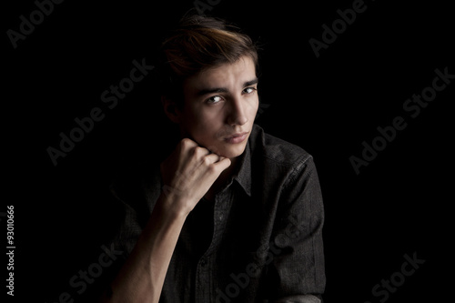 portrait of a young handsome man on black background