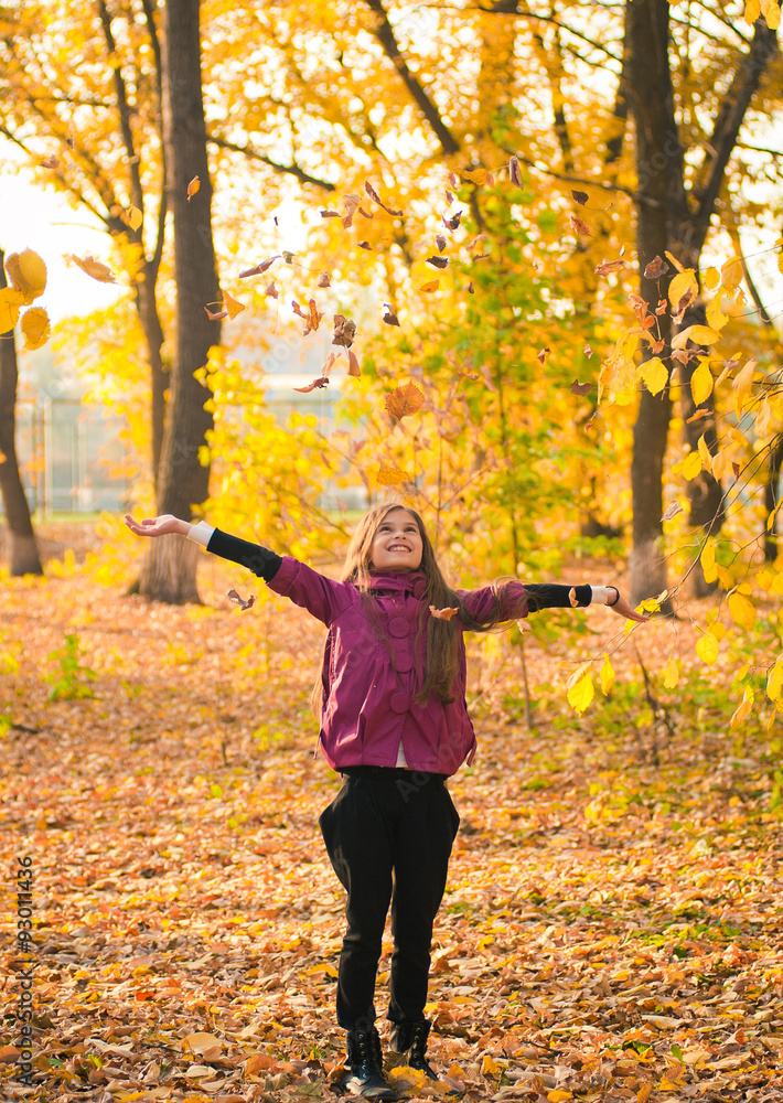 Smiling girl with autumn maple leaves at fall outdoors Smiling girl with autumn maple leaves at fall outdoors