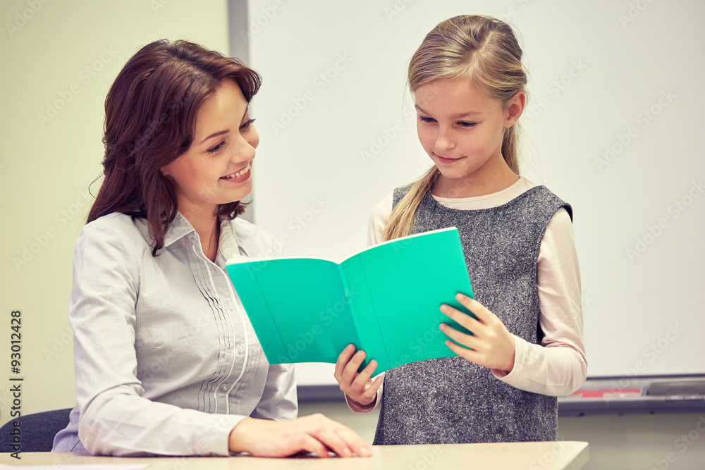 school girl with notebook and teacher in classroom school girl with notebook and teacher in classroom