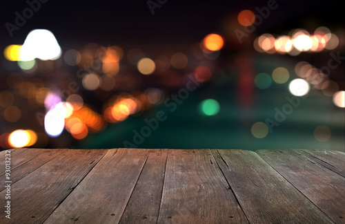 Wood table with city lights night blurred background
