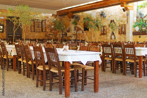 Mediterranean restaurant terrace exterior with chairs. © M-Production