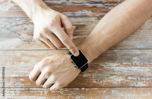 close up of male hands setting smart watch