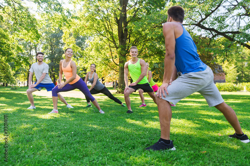 group of friends or sportsmen exercising outdoors