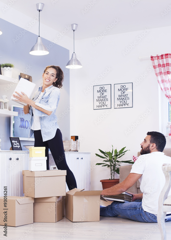 Portrait of a smiling couple packing boxes in a new house Portrait of a smiling couple packing boxes in a new house