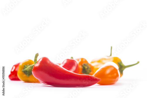 Obraz na płótnie Red, yellow and orange pepper on white background w salonie