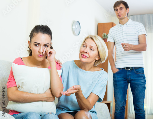 Mother-in-low comforting girl after quarrel with husband