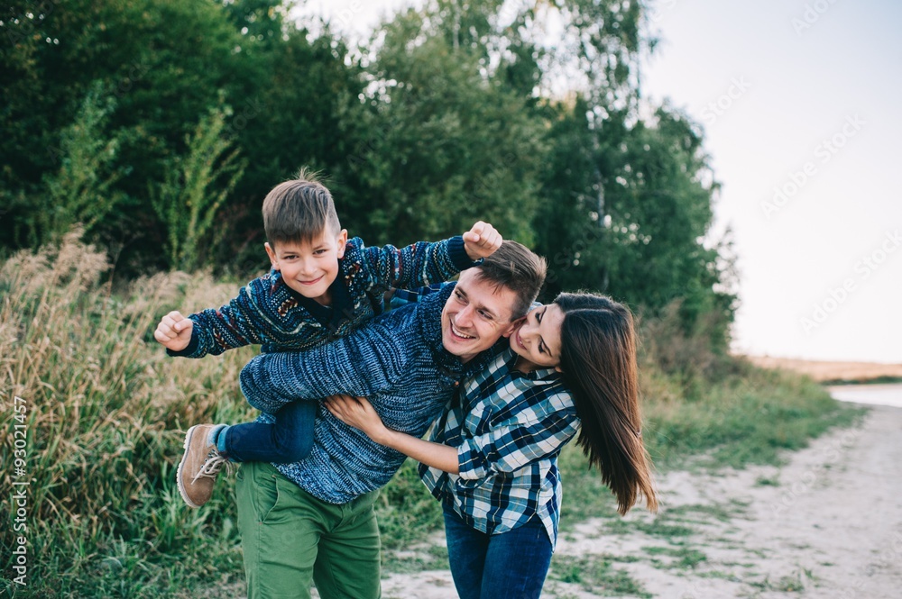 vacation young family near the lake, happy father, mother and so vacation young family near the lake, happy father, mother and so