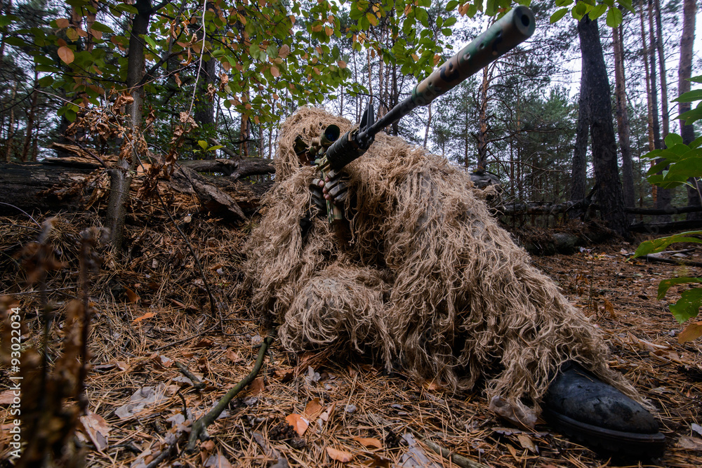 Camouflaged sniper lying in forest and aiming through his scope Stock Photo  by ©Nesterenko_Max 89112398