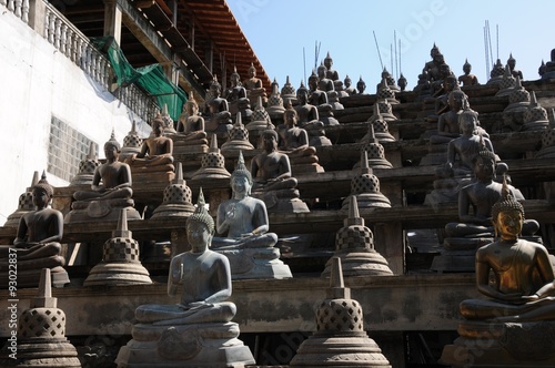 Set of Buddha statues and small stupas in Gangaramaya temple, photo