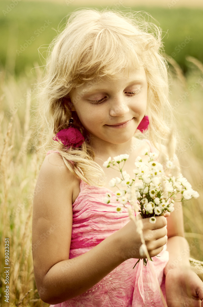 girl holding bunch of flowers