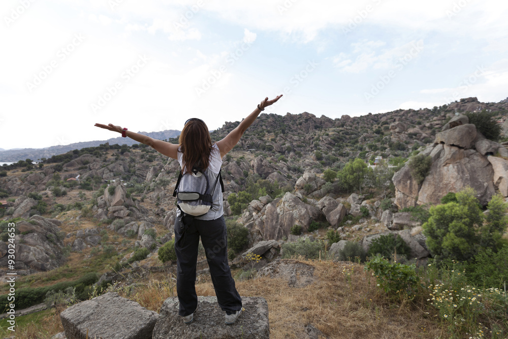 Healthy and happy young woman greets the mountain Healthy and happy young woman greets the mountain