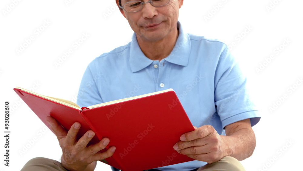 Old man sitting on the floor reading Old man sitting on the floor reading