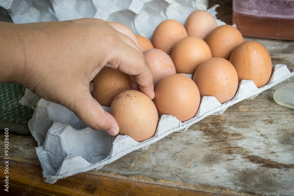 hand pick up eggs in carton