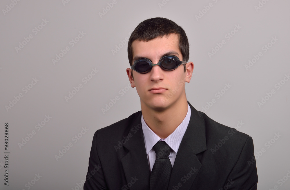 Successful businessman wearing goggles for water, thinking at va Successful businessman wearing goggles for water, thinking at va
